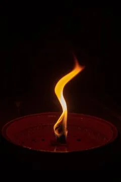 Candle flame close up on dark background, interesting flame figure Stock Photos