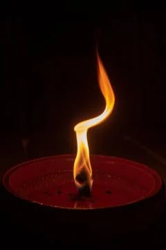 Candle flame close up on dark background, interesting flame figure Stock Photos