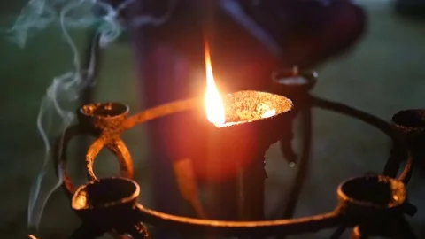 Candle flame close-up in the Indian Temple on a Religious Festival Diwali. .. Stockbeeldmateriaal 74875779