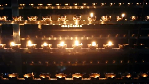 Candle flame close-up. Many Candles in a Buddhist temple. Religious Festival. Stock Footage 88133031