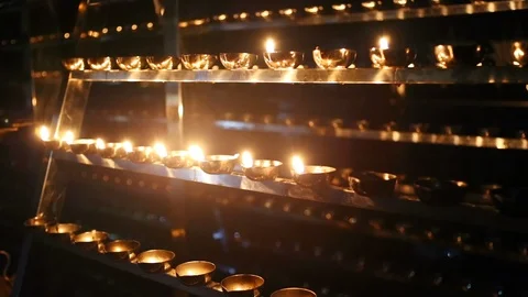 Candle flame close-up. Many Candles in a Buddhist temple. Religious Festival. Stock Footage 88133090