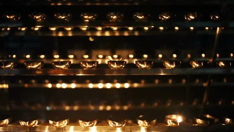 Candle flame close-up. Many Candles in a Buddhist temple. Religious Festival. Stock Footage 88133262