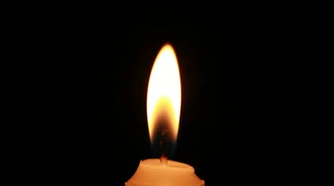 Candle flame closeup on black background Stock Footage