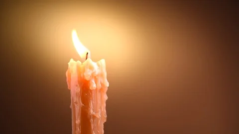 Candle flame closeup on dark background. Candle light. Melted wax candle Stock Footage 99347686
