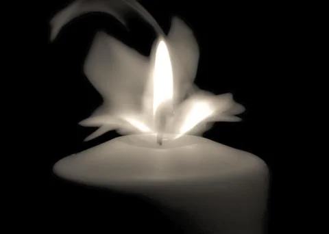 Candle flame in the dark background and space for text.. Stock Photos