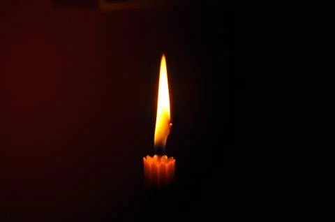 Candle with flame in dark background 写真素材