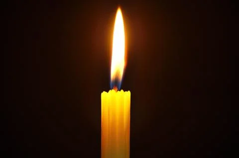 Candle with flame in dark background Foto stock
