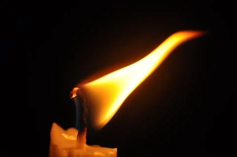 Candle with flame in dark background Foto stock