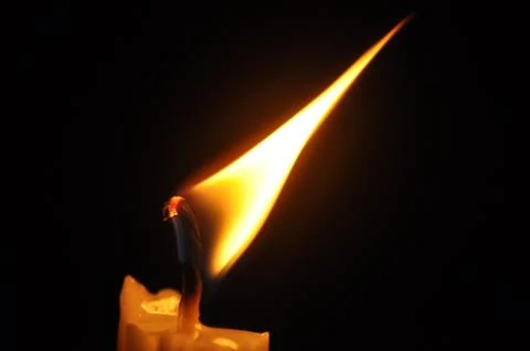 Candle with flame in dark background Foto stock