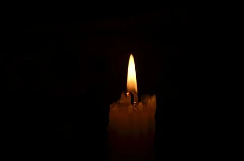Candle flame on dark background Stock Photos