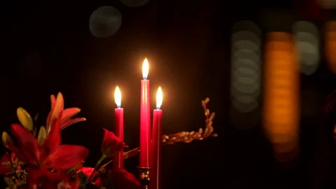 Candle flame on a dark festive red background Stock Footage 235889590