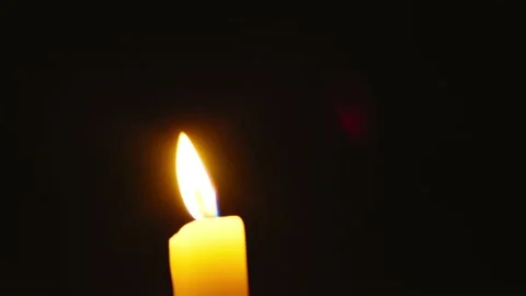 Candle flame in darkness Stock Footage 132354601