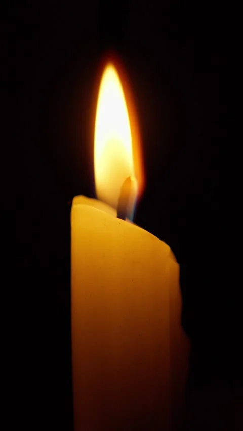 Candle flame flickering with melting wax on black Stock Footage 344790225