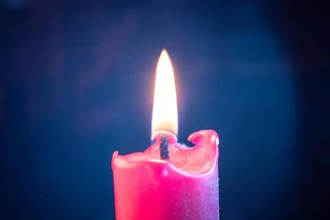 Candle flame flickers in the wind Stock Photos