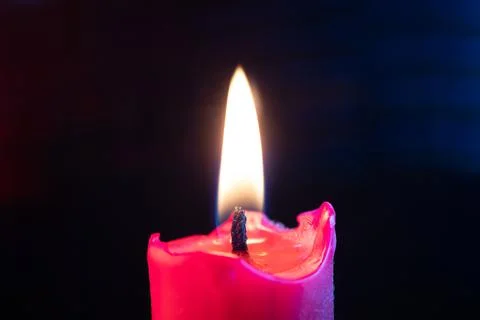 Candle flame flickers in the wind Stock Photos