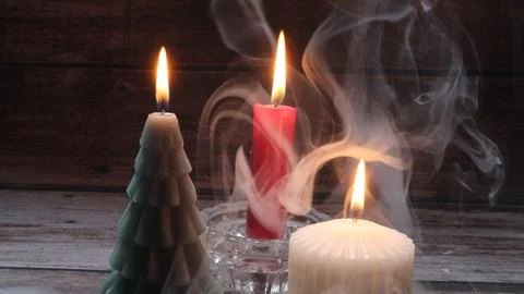 Candle flame flickers in the wind Stock Photos