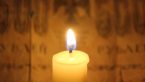 Candle flame lights up old paper money, the pasty of the past Stock Footage 89006167