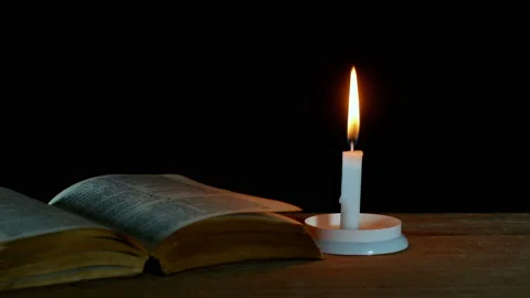 Candle flame old book on old table on dark Background. Stock Footage 151490850