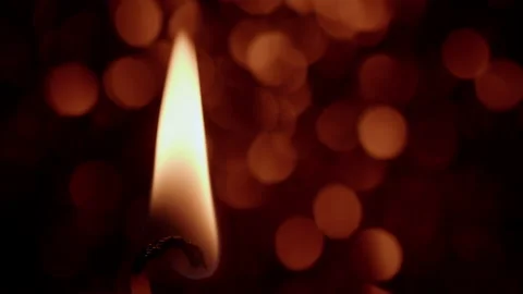Candle flame with an out of focus reflective background. 4K tripod macro shot. Stock Footage 145363304