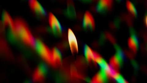 Candle Flame surrounded by a halo of multi-colored diffraction glares Stock Footage 120827971