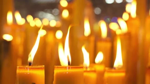 Candle flames burn in the temple. Stock Footage 219035358