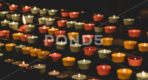 Candle flames glowing in the dark, create a spiritual atmosphere Stock Photos