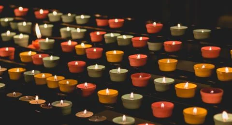Candle flames glowing in the dark, create a spiritual atmosphere Stock Photos