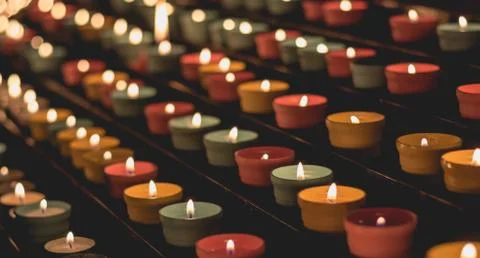 Candle flames glowing in the dark, create a spiritual atmosphere Stock Photos