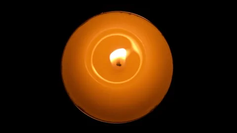 Candle flickering in the dark. Top view. White round candle burning on the dark Stock Footage 167339461
