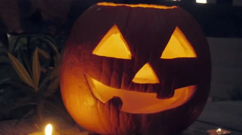 Candle Flickers inside a Jack o'lantern Pumpkin Stock Footage 68934596