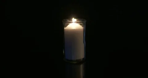Candle in glass on dark background Stock Footage 74350218