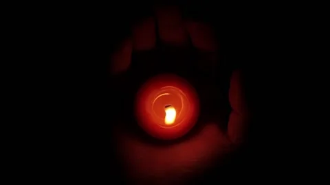 Candle Is Glowing in Person’s Hand over Dark Background Stock Footage 203913606