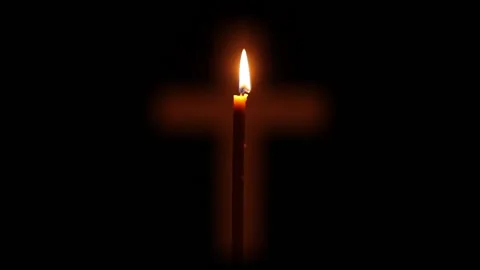 Candle Is Glowing through Hole in Shape of Christian Cross Stock Footage 203912936