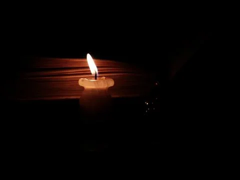 Candle illuminates the book 写真素材