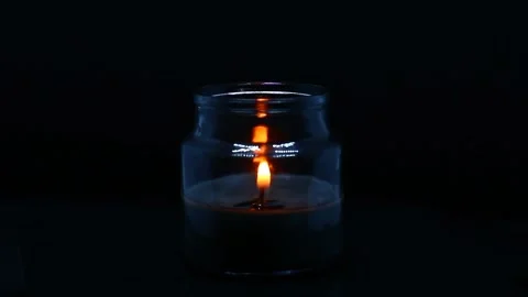 Candle in the jar on black background Stock Footage 223191911