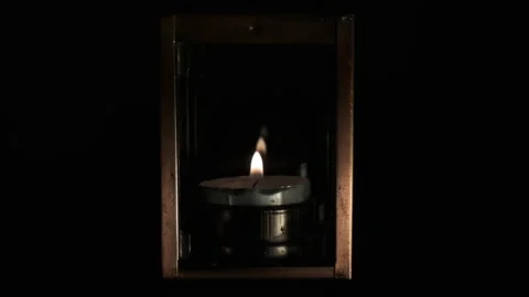 A candle in a lamp and the reflection of the candle flame in the glass Stock Footage 146068051