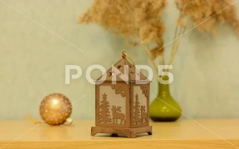 Candle lantern with a Christmas tree and reindeer, a tree toy and pampas grass Stock Photos