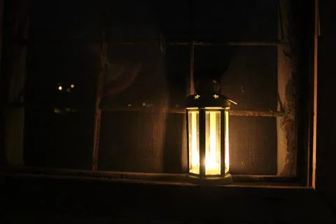 Candle lantern in the window Stock Photos