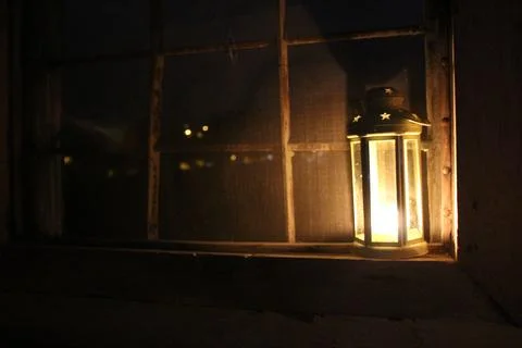 Candle lantern in the window Stock Photos