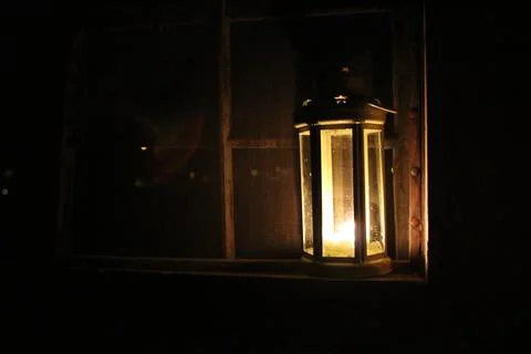 Candle lantern in the window Stock Photos
