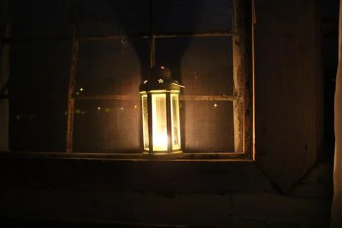 Candle lantern in the window Stock Photos