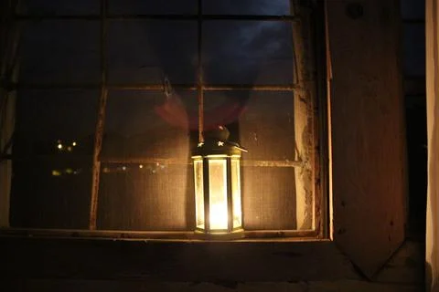 Candle lantern in the window Stock Photos