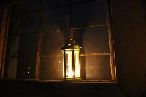 Candle lantern in the window Stock Photos