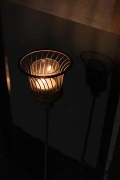 Candle light in basket with shadow Stock Photos