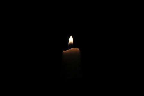 Candle light on a black background, close-up of photo Stock Photos