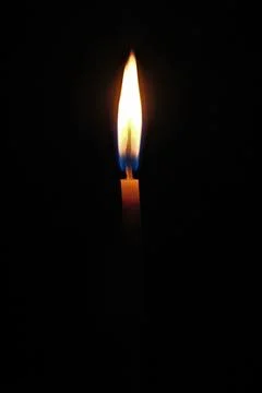 Candle light on a black background, close-up of photo Foto stock