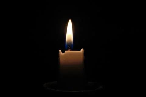 Candle light on a black background, close-up of photo Stock Photos