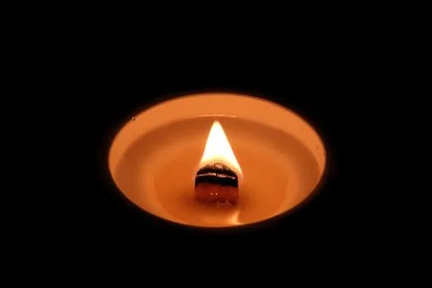 Candle light on a black background, close-up of photo Stock Photos