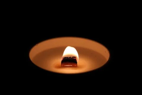 Candle light on a black background, close-up of photo Foto stock