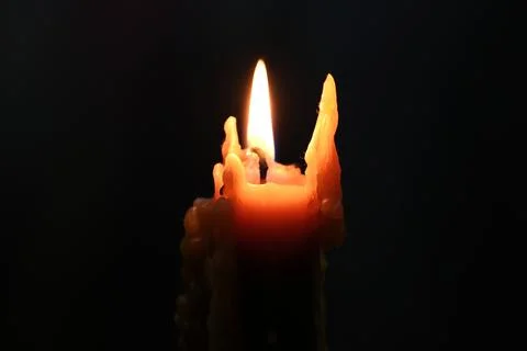 Candle light on a black background, close-up of photo Stock Photos